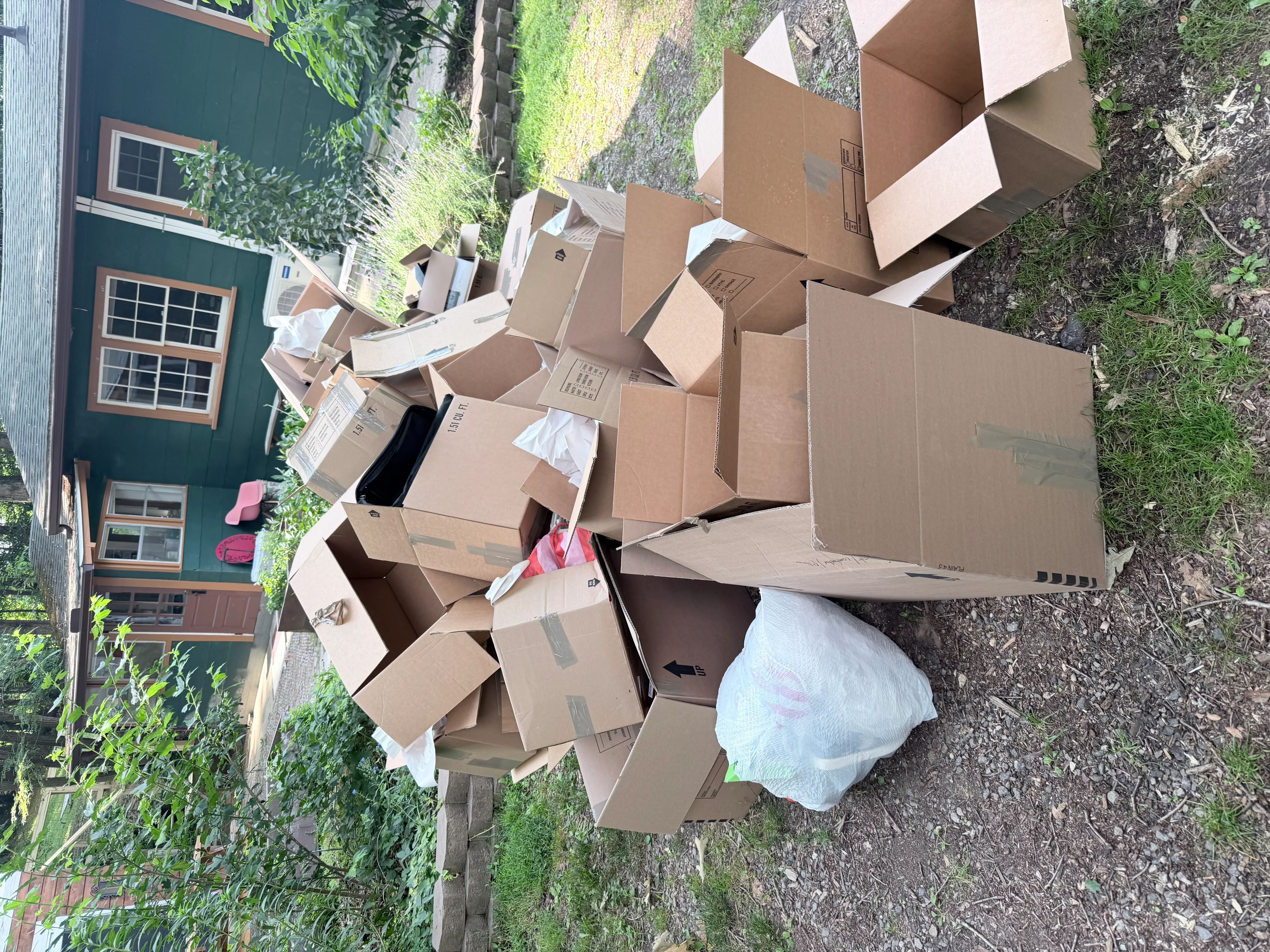 Pile of cardboard boxes and household items ready for junk removal hauling